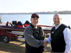 RCB Bank Loan Officer Roger Evans (right) helps Jamie Moore reel 
in the savings on his new summer cruiser.