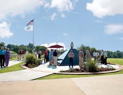 Visitors gather around the OMA Killed in Action Memorial on the RSU campus.