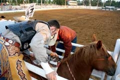 Matt Bright, a three-time Wrangler National Finals Rodeo qualifier, sets his rigging before his ride at the 2012 Will Rogers Stampede. Bright is one of numerous NFR ­qualifiers who plan to be in Claremore for the 2013 ­Stampede, which will be produced by elite stock ­contractor Carr Pro Rodeo and Pete Carr’s Classic Pro Rodeo. Photo by Ted Harbin