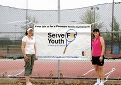 Mendy Stone and Liz Cary stand in front of the Claremore courts, where the fifth annual Serve for Youth will be held May 30-June 1.