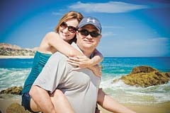 Will and Jennifer on the beach in Cabo, Mexico on one of their free Zeal vacations.
