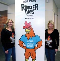 April Sailsbury, Broken Arrow Chamber of ­Commerce, and Kristi Brooks, TTCU The Credit Union, with a sample of the new “Rooster Wraps” that were ­available to businesses ­sponsoring Rooster Days.