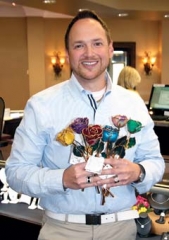 Joel Wiland, owner of J. David Jewelry, with a bouquet of 24 karat roses in birthstone colors, an ideal gift for Mother’s Day.