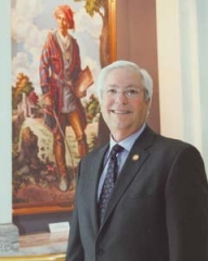 Principal Chief Bill John Baker at the Oklahoma State Capitol with the painting of Sequoyah.