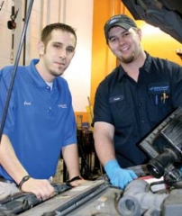 Quick Lane Manager Josh Bollig and Service Technician Justin Watson finish up finish up oil and filter services on a client’s vehicle.