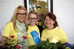 Olivia Lee, Abby Henry and Debbie Wilson of Ted & ­Debbie’s Flower & Garden, at last year’s Spring in 
the Square.
