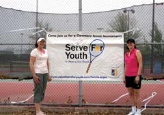 Mendy Stone and Liz Cary stand in front of the ­Claremore courts where the third annual Serve for Youth will be held May 11-13.