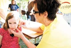 Deborah from the Bridge Church in Bixby does face painting in the Kids Zone tent at last year’s Bixby BBQ ’n Music Festival.