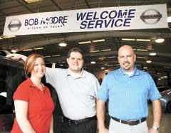 Service Director Steve Thomasson (center) and Service Advisors Tammy Medina and Patrick Weir welcome customers as they enter the service drive at Bob Moore Nissan of Tulsa.