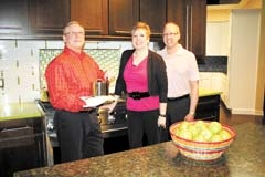 Jodie DeArmon, Joan Smith-Murphy and Bob Barnes in a contemporary chef’s kitchen.