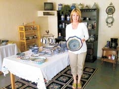 Leslie Cohen, owner of The Pottery Cottage, with a large Polish pottery serving bowl, which makes a perfect gift for any occasion.