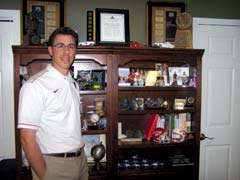 David Merriman by the shelf in his office that keeps his ­priorities front and center.