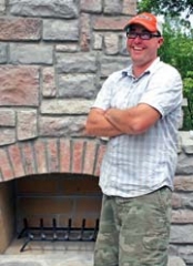 Tulsa Stone and Brick Works owner Randy Sissom at a work-in-process job site featuring an outdoor fireplace and patio.