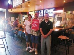 (L to R): Tanya Andrews, executive director, Visit Claremore; Dwayne Caldwell; Rick Hatley, general manager, Buffalo Wild Wings.