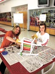 Mendy Stone and Kealy work on their chair for the auction.