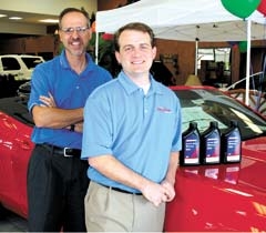 Joe Gibson and Kaelen Knight of Jim Glover Chevrolet with samples of the new Dexos 1 motor oil, the new ­standard recommended for most Chevrolet vehicles.