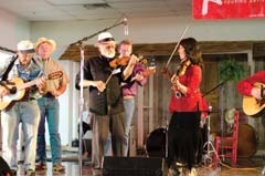 Jana Jae, founder of the American Heritage Music Festival, with 
violinist Buddy Spiecher and other musicians at last year’s event.