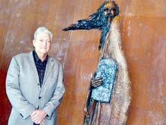 Museum Executive Director Arthur Feldman stands ­beside “Moses,” by Gib Singleton, one of the offerings made possible in part by funds raised from Treasures in Your Attic.