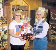 Hazel Ward of The Nut House in Claremore presents a basket of “nutty” goodies to satisfy your sweet tooth to Jerry Jones, Rogers County Literacy Council tutor trainer. The basket is just one of over 50 items to be auctioned to raise money for the RCLC.