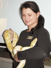 ­Kids at Summer SeaCamp 2010 can meet and greet Xena, an albino Burmese python, and learn more about her from Education Specialist Michelle Zarantonello.