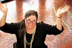 Melanie The Money Maven on Waterstone’s lobby floor creatively tiled with 100,000 pennies.