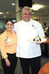 Kalli Castille, director of national support and culinary at CTCA, and John Oje, executive sous chef, show off a plate of Wild Berry Shortcake, one of the sugar-free/gluten-free desserts you can learn to make July 21 at the hospital.