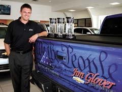 Jared Glover and the Jim Glover Chevrolet team are proud of their achievement in being awarded Chevrolet Dealer of the Year for the past three years. Jared is pictured with the awards and a special wrapped Silverado that will be seen at special events this summer.