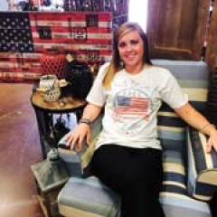 Surceé employee Courtney Vanlandingham models a patriotic T-shirt in one
of the store’s summer vignettes.