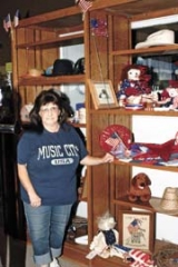 Thrift Harbor volunteer Crystal Dancer prepared the Fourth of July merchandise display so customers can find just the right item for their holiday decorating needs.