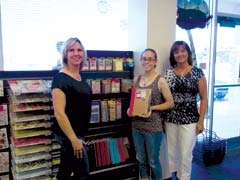 Jerri Ann Currey, Elyssa Kaufman, and Lee Ann Hixson are celebrating The Scrapbook Store’s seven years in business.
