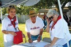 Ropers Hoytanna Benigar (left) and Carlene Webber greet pilots and spectators for the Will Rogers-Wiley Post Fly-In.