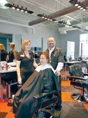 Paula Matthews and Shon Schaller work their haircutting magic on a client of Oklahoma Technical College’s Barber School.
