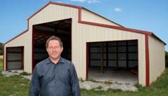 Carl Parson with a pole barn under construction by Inola Portable Buildings &amp; Pole Barns.