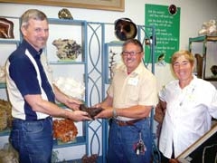 Roger Bush, director and curator of Elsing Museum: God’s Natural Art Museum, holds a meteor rock with Paulino and Julia Allende, long-time members of the Tulsa Rock and Mineral Society.