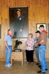 Larry and Marion Leep from Baltic, Conn. talk with Will Rogers Ropers (docents) Tom Lingenfelter and Ken McSlarrow during their visit to Will Rogers Memorial Museum in Claremore.