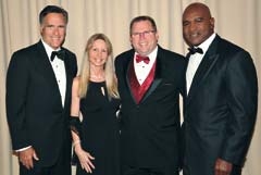 Ronda and Thomas Scott, pictured with Mitt Romney and Evander Holeyfield at the Charity Vision fight night in Salt Lake City, Utah on May 15. AAMCO was a sponsor of the event, which raised over $1.2 million for those in need of vision care.