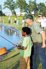 Information and Education Specialist Mike McAllister leads a Family Fishing Clinic at Zebco Casting Pond.
