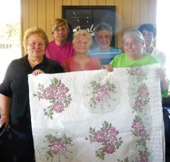 Members of the ESA Gamma Pi Chapter in Inola hold the hand-embroidered quilt that will be raffled at Bunco in 2013. 
(L to R): (back row) Karla Applegate, Mary Adams, Bobbie Martin, (front row) Carol Applegate, Gertrude Riddle and Carolyn Domier.
