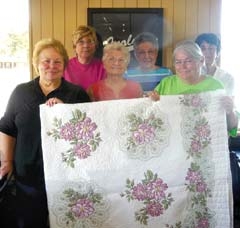 Members of the ESA Gamma Pi Chapter in Inola hold the hand-embroidered quilt that will be raffled at Bunco in 2013. 
(L to R): (back row) Karla Applegate, Mary Adams, Bobbie Martin, (front row) Carol Applegate, Gertrude Riddle and Carolyn Domier.