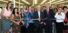 Ronny Altman, Goodwill board member and former chairman of the board, does the ribbon cutting honors celebrating the grand opening of the new Goodwill store and donation center in Glenpool.