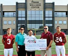 Akira Sushi Bar presented a $5,000 donation to Owasso Rams Football in July. (L to R): Senior Corner Back Tyler Lindsey, Akira Owners Quinton Wong and Huy Huynh, Booster Club President Dugg Holeman, and Senior Free Safety Josh Kinzer.