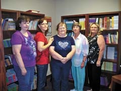 Caring Grands Karen Hochhalter, Debbie Marshall, Patty Richie, and Barbara Morris with Instructor Donna Hall stand in the Caring Grand Resource Room.