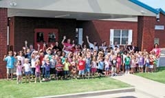 Children representing pre-K through first grades enjoy summer activities offered at Cross Timbers School in Owasso.