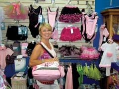 Owner Cindy Rickard stands beside her ever-growing line of dance clothing and accessories at Emily’s Playhouse.