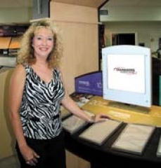 Grigsby’s Carpet Specialist Cindy Gowing at the Stainmaster kiosk that helps customers understand available styles, features and benefits of Stainmaster Carpets.