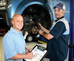 Joe Marina Honda Express Service Manager Michael Yarber discusses a brake issue with Service Technician Chad Hargrove.