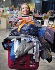 A shopper loads up on ­low-price goodies at a Just Between Friends ­consignment sale.