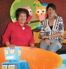 Downtown Broken Arrow merchants Laurann Farris and Alisa Inglett show off creative children’s murals by Brandi Alltizer, whose murals will be featured at the Heart of Broken Arrow Arts &amp; Crafts Fair.