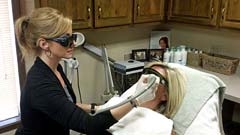 Licensed Aesthetician Gina Picart uses the Cutera Coolglide to remove hair from a patient’s face.