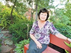 Lisa Mitchell, media chair for the Living with Art in the Garden Tour, sits in Lynn Dickason’s garden at 4747 S. Yorktown Pl. in Tulsa.